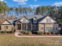 Charming single-Gathering home featuring stone and brick accents, a welcoming front porch, and well-manicured landscaping at 462 Barber Loop, Mooresville, NC 28117