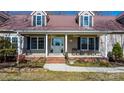 Inviting front porch with seating, featuring a charming entryway and enhancing the home's curb appeal at 468 White Oak Branch Rd, Statesville, NC 28625