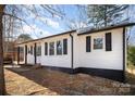 Exterior side view of home showcasing siding, black shutters, and a well-maintained yard at 523 Hickory Nut Ln, China Grove, NC 28023