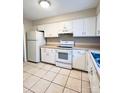 Bright kitchen with white cabinets, appliances and tile flooring at 5810 Hunting Ridge Ln # C, Charlotte, NC 28212