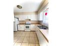 Bright kitchen with white cabinets, appliances and tile flooring at 5810 Hunting Ridge Ln # C, Charlotte, NC 28212