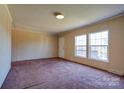 Bright living room with large windows and plush carpeting, perfect for relaxation and entertaining at 828 Carver St, Shelby, NC 28152
