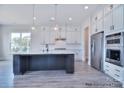 Bright kitchen features a spacious island, stainless steel appliances, and stylish pendant lighting at 000 Millstream Rd # 149, Denver, NC 28037