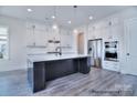 The bright kitchen showcases a center island, modern appliances, and ample cabinet space at 000 Millstream Rd # 149, Denver, NC 28037