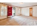 Inviting living room with a red front door, neutral carpet, and classic wallpaper border at 1007 Wentworth Dr, Kannapolis, NC 28081