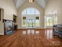 Expansive living room with fireplace, grand windows, and hardwood floors provides an elegant gathering space at 107 Sunderland Dr, Shelby, NC 28150