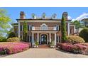 Elegant brick home with a covered front entrance and lush landscaping at 131 The Point Dr, Mooresville, NC 28117