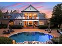 Resort-style backyard with a sparkling pool and outdoor dining area at 131 The Point Dr, Mooresville, NC 28117