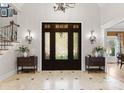 Elegant foyer with marble floors, a decorative front door, and a staircase leading to the upper level at 13215 Claysparrow Rd, Charlotte, NC 28278