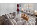 Bright living room with neutral furniture, a patterned rug, and ample natural light at 134 Burke Cir, Mooresville, NC 28115