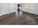 Spacious living room featuring hardwood floors and a bright red front door at 134 Burke Cir, Mooresville, NC 28115