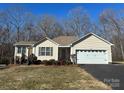 Well-maintained single-story home featuring a two-car garage and a cozy front entrance at 1420 28Th Sw St, Hickory, NC 28602