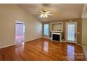 Bright living room with hardwood floors, fireplace, ceiling fan, and access to other rooms at 1420 28Th Sw St, Hickory, NC 28602