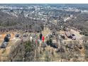 Aerial view of a house nestled in a wooded neighborhood with mature trees and surrounding roads at 1547 Kings Rd, Shelby, NC 28150