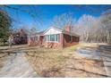 A charming brick home with a paved walkway, and a well-manicured lawn at 1547 Kings Rd, Shelby, NC 28150
