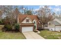 Attractive two-story home with a two car garage and sidewalk leading to the front door at 207 Pebble Creek Xing, Fort Mill, SC 29715