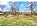 Sprawling property showcasing a charming brick home with ample green space and surrounding trees at 222 Weldon Cir, Mount Holly, NC 28120