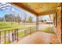 Charming front porch with mosaic flooring and wrought iron railings, offering a welcoming entrance at 222 Weldon Cir, Mount Holly, NC 28120