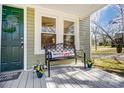 Inviting front porch with a comfortable bench, potted flowers, and stylish decor, creating a cozy outdoor space at 240 N Lackey St, Statesville, NC 28677