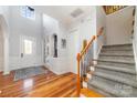 Bright and airy foyer featuring hardwood floors, stairs with carpet runner, and a front door with glass inserts at 3046 Denali Way, Rock Hill, SC 29732