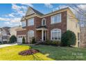 Beautiful brick and siding home featuring a well-manicured lawn, landscaping, and an attached two-car garage at 3046 Denali Way, Rock Hill, SC 29732