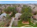 Expansive aerial shot of the home, showcasing its large lot, mature trees, circular drive, and proximity to surrounding neighborhood at 308 Covington Xing, Weddington, NC 28104