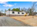 Charming single-story home with a fresh gravel driveway and a neatly maintained front lawn at 3365 34Th Avenue Ne Ct, Hickory, NC 28601