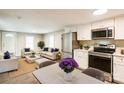 Open-concept living space featuring new stainless steel appliances and neutral-toned furniture at 343 Bell St, Mooresville, NC 28115