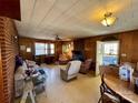 Cozy living room features a brick fireplace, wood paneling, and natural light at 4073 Lee Cline Rd, Conover, NC 28613