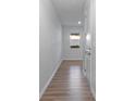 Light-filled entryway features wood-look flooring, neutral paint, and a convenient closet for storage at 419 Burr St, Indian Trail, NC 28079