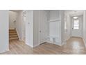Bright hallway showcases wood-look floors, access to stairs, and a built-in drop zone at 419 Burr St, Indian Trail, NC 28079