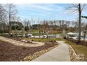 Stone path leading to a beautiful waterfront view with boat docks and well-maintained landscaping at 4543 Stonesthrow Dr, Denver, NC 28037