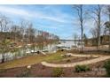 Scenic waterfront view with multiple boat docks, manicured lawns, and a tranquil atmosphere at 4543 Stonesthrow Dr, Denver, NC 28037