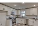 Bright kitchen with stainless steel appliances, granite counters, and white shaker cabinets at 502 9Th Sw Ave, Conover, NC 28613