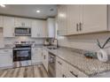 Modern kitchen with white cabinets, granite countertops, and stainless steel appliances at 502 9Th Sw Ave, Conover, NC 28613