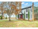 Well-maintained home with a red front door and beautifully landscaped yard at 8730 Rittenhouse Cir, Charlotte, NC 28270