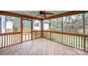 Cozy screened porch with wood flooring and ceiling fan, perfect for outdoor relaxation at 8730 Rittenhouse Cir, Charlotte, NC 28270