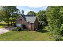Brick home with attached garage, fenced yard and a view of the back deck at 912 Silver Charm Ln, York, SC 29745