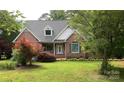Well-maintained brick home with a lush front yard and decorative trees at 912 Silver Charm Ln, York, SC 29745