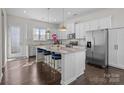Modern kitchen with stainless steel appliances, granite countertops, island with seating, and ample cabinet space at 9804 Ainslie Downs St, Charlotte, NC 28273