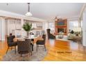 Open-concept living room and dining area with fireplace, hardwood floors, and bar seating at 1003 Oak Hill Dr # 24, Monroe, NC 28112