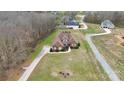 Aerial view of the home with a long driveway and well-maintained lawn and landscape at 1011 Duntov Dr, Monroe, NC 28110
