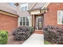 Inviting front entrance with brick accents and a landscaped walkway at 1011 Duntov Dr, Monroe, NC 28110