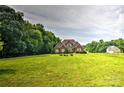 Spacious lawn with mature trees surrounding a lovely brick home at 1011 Duntov Dr, Monroe, NC 28110