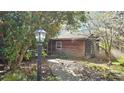 Cozy wooden cottage with a peaceful garden path, providing a serene retreat at 1116 Medlin Rd, Monroe, NC 28112