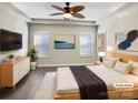 Serene main bedroom with a tray ceiling, recessed lights, and neutral décor at 13811 Waverton Ln, Huntersville, NC 28078