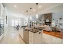 Modern kitchen with a large island, stone countertops, stainless steel appliances, and an open view to the living area at 165 Blue Ridge Trl, Mooresville, NC 28117