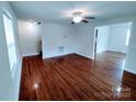 Living room with hardwood floors, ceiling fan, and access to other rooms of the house at 1806 Bringle Ferry Rd, Salisbury, NC 28146