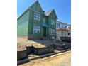 Under construction home featuring large windows, green sheathing and brick foundation on a sunny day at 19032 Newburg Hill Rd, Davidson, NC 28036