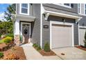 Beautiful townhome front exterior featuring a garage door and a modern door with glass paneling at 2310 Hedgecliff Rd # 159, Kannapolis, NC 28025